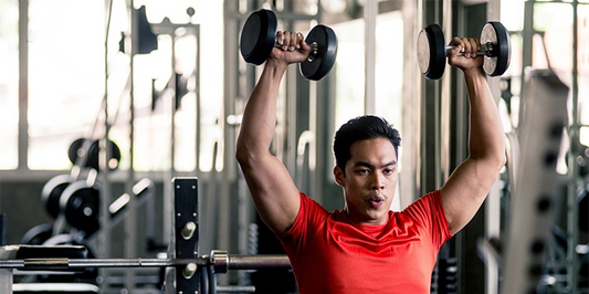 Stamina for Men - Man wearing red shirt lifting dumbbells in the gym, fitness gym, healthy exercise guidelines concept.