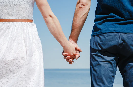 Stamina for Men swinger couple holding hands at the beach
