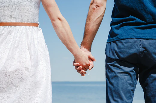 Stamina for Men close up image of loving couple holding hands on a beach near the sea