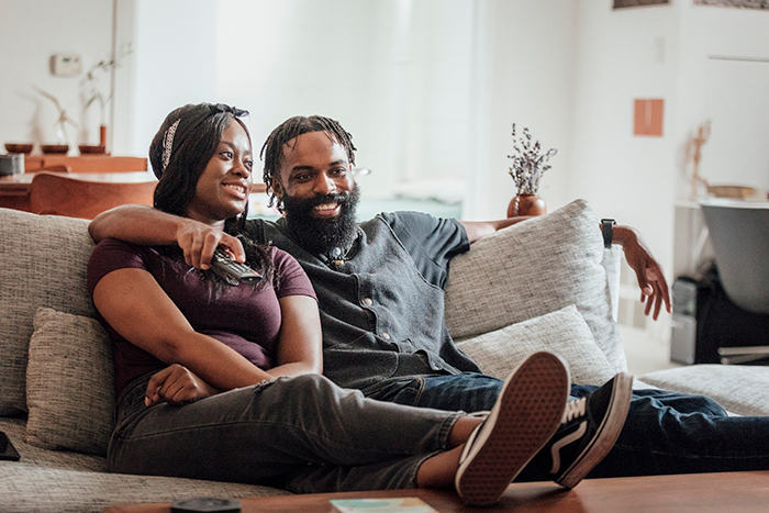 Image of Stamina for Men smiling couple on couch watching tv